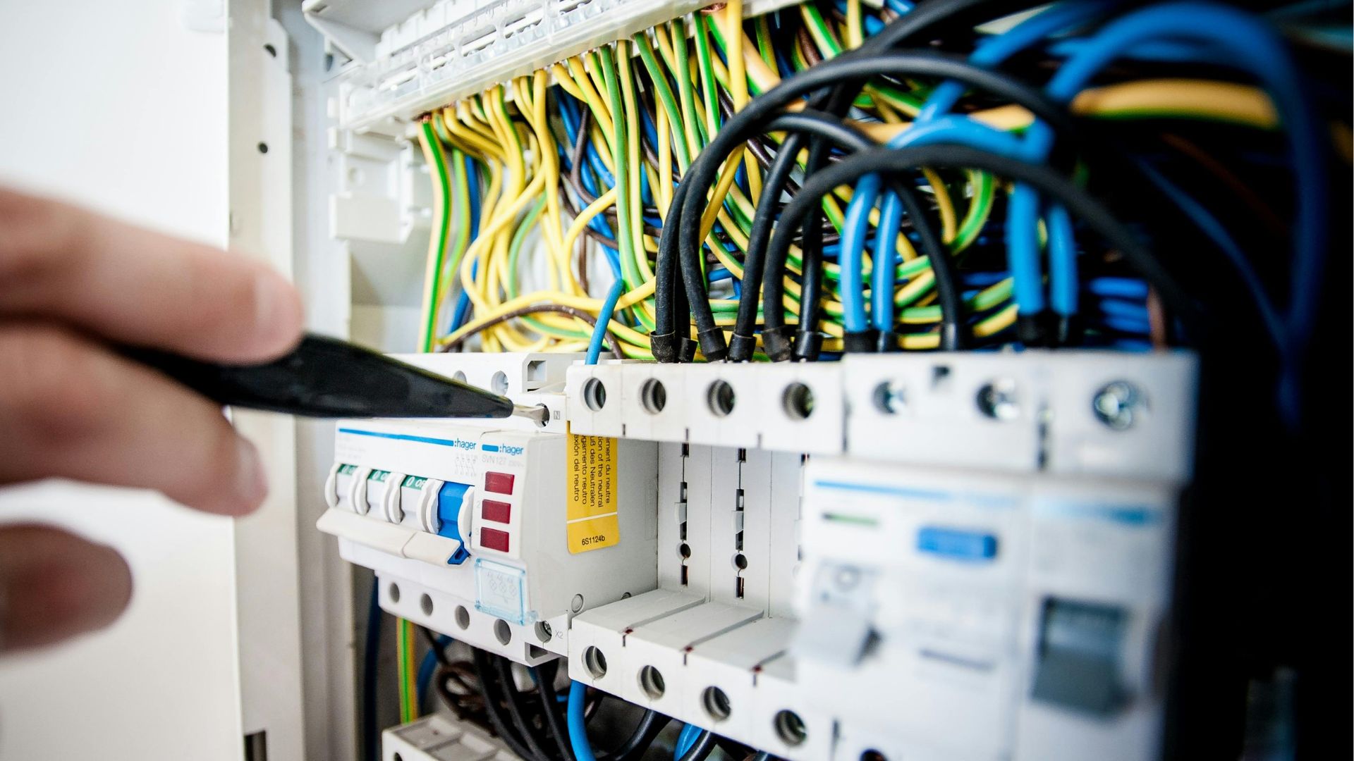 Electrician completing a service upgrade on a commercial property at dusk
