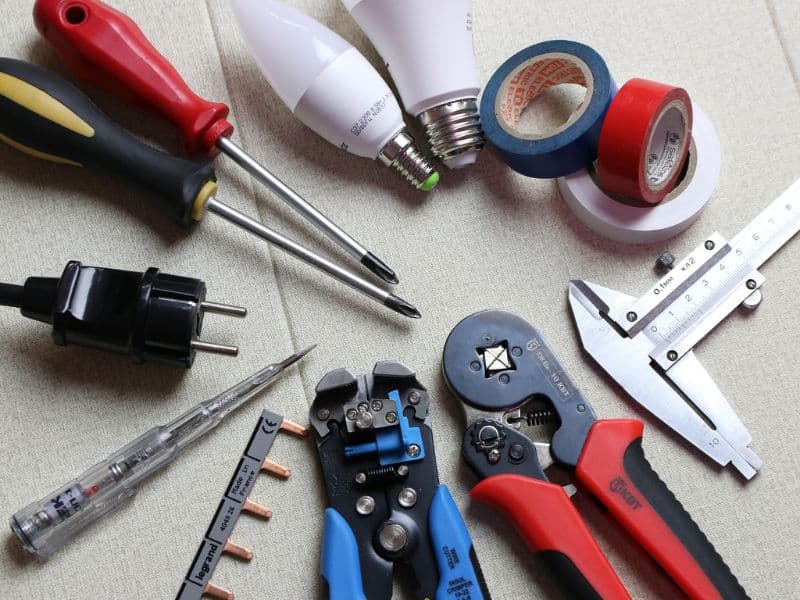 Electrician installing recessed LED lighting in a residential kitchen